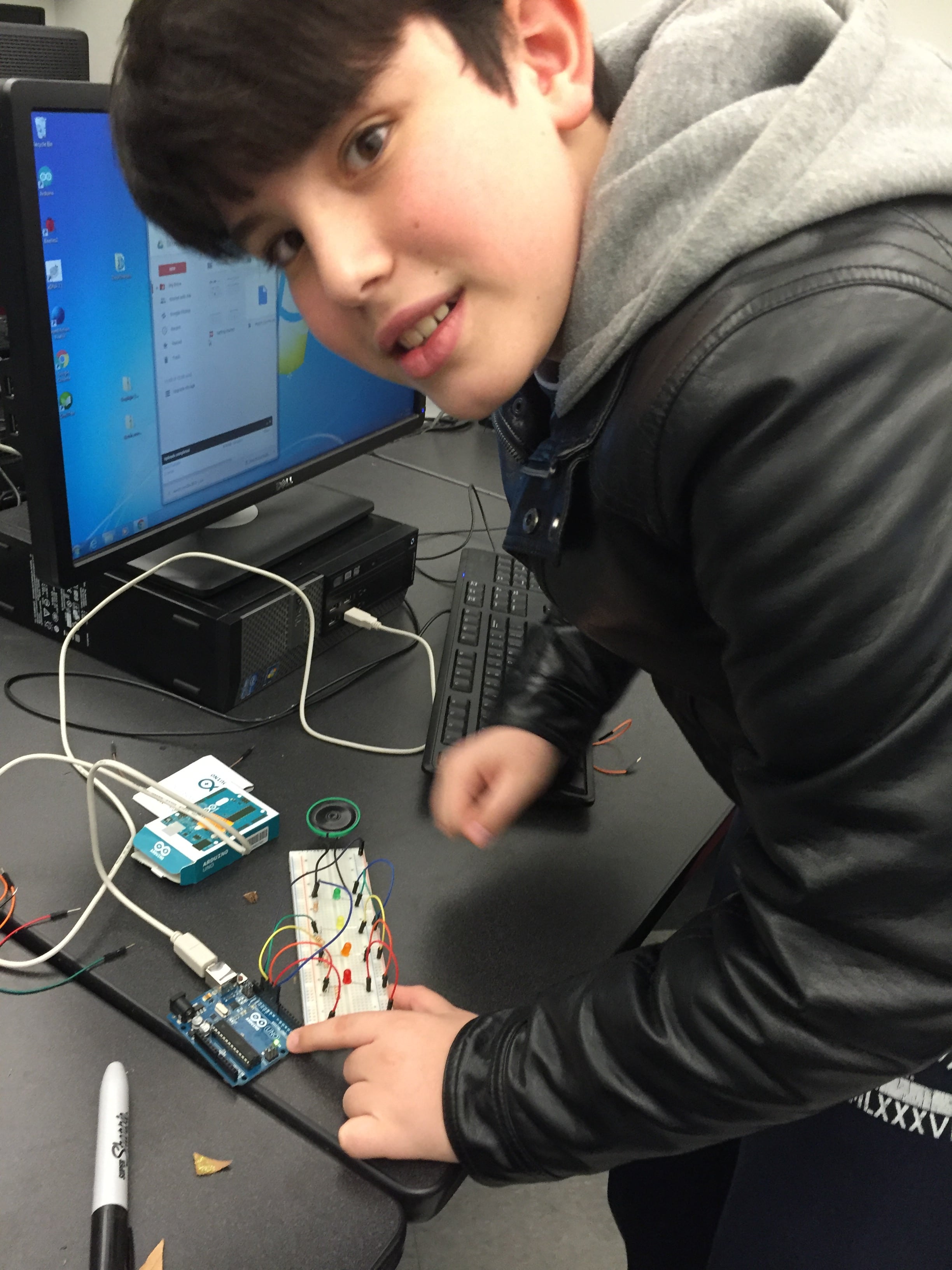 Young boy experimenting with circuit board.